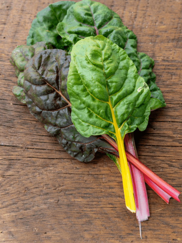 Swiss chard leaves and stalks laying on a table